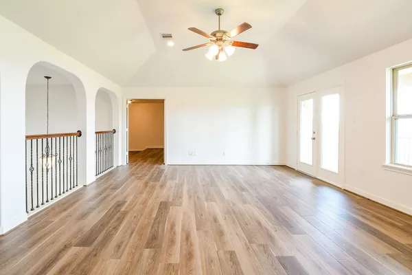 wooden floor in an empty room with a window