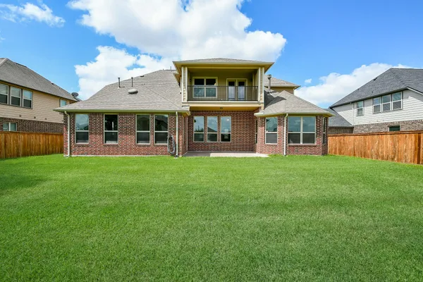 a view of a house with a yard and sitting area