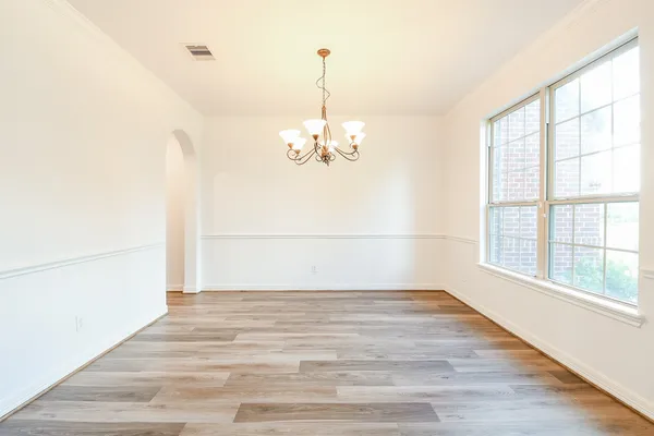 a view of a room with wooden floor and large window