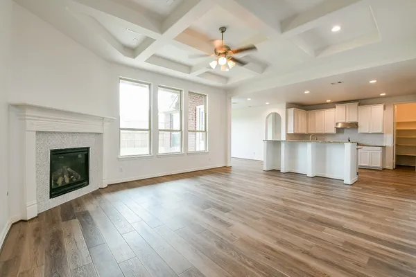 a view of a kitchen with a stove cabinets wooden floor and a kitchen