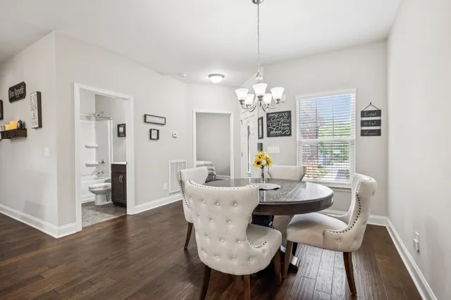 a large kitchen with a table and chairs