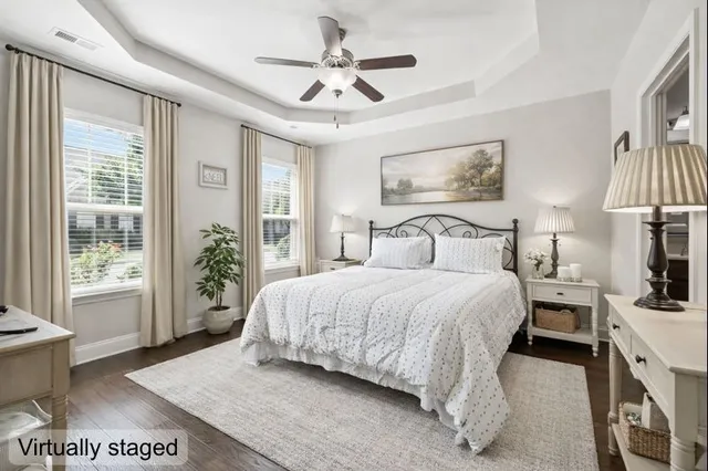 a bedroom with a bed and a large window