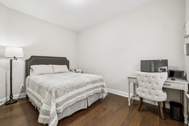 a bedroom with a bed and a desk