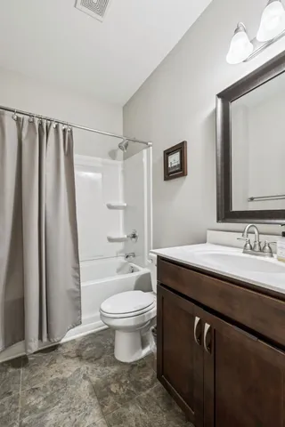 a view of a patio with couple of chairs and a potted plant