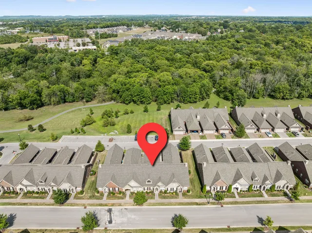 an aerial view of a house with a yard