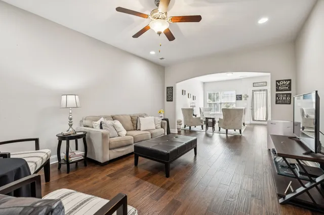 a living room with furniture and a wooden floor