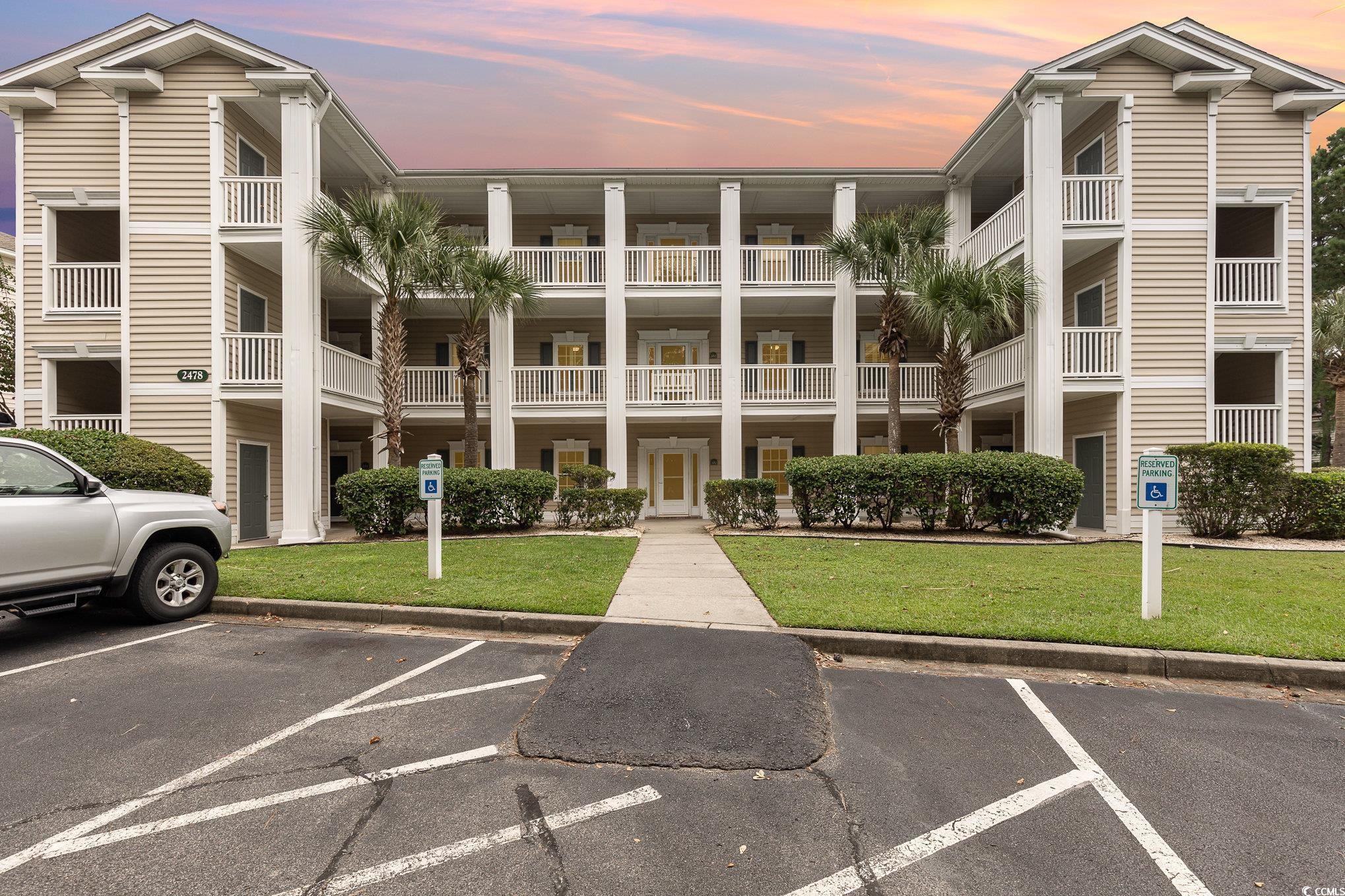 2478 Coastline Court, Unit 202 Murrells Inlet, SC 29576 - Photo 1 of 33 View of outdoor building at dusk