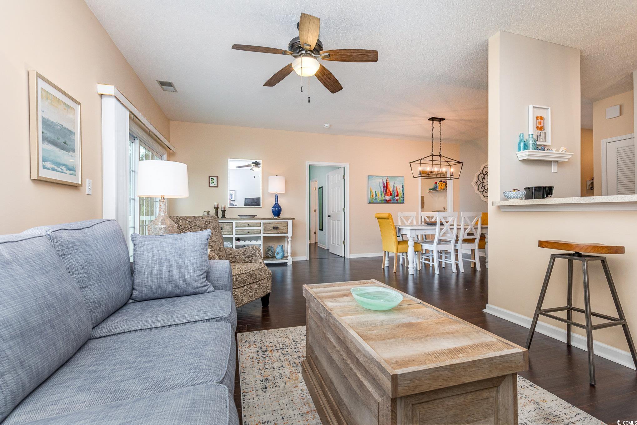 2478 Coastline Court, Unit 202 Murrells Inlet, SC 29576 - Photo 11 of 33 Living room with ceiling fan with notable chandeli