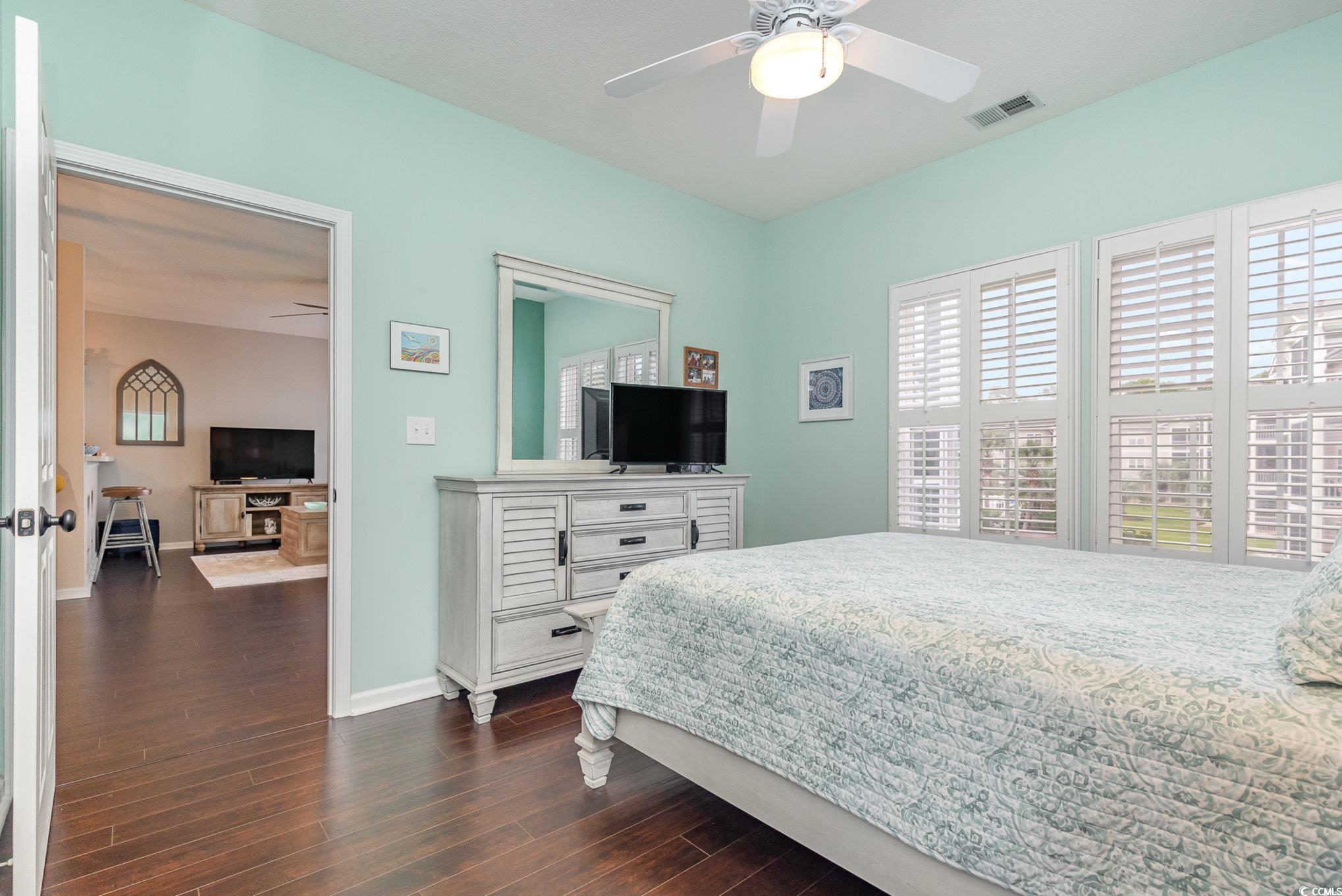2478 Coastline Court, Unit 202 Murrells Inlet, SC 29576 - Photo 14 of 33 Bedroom featuring ceiling fan and dark hardwood /