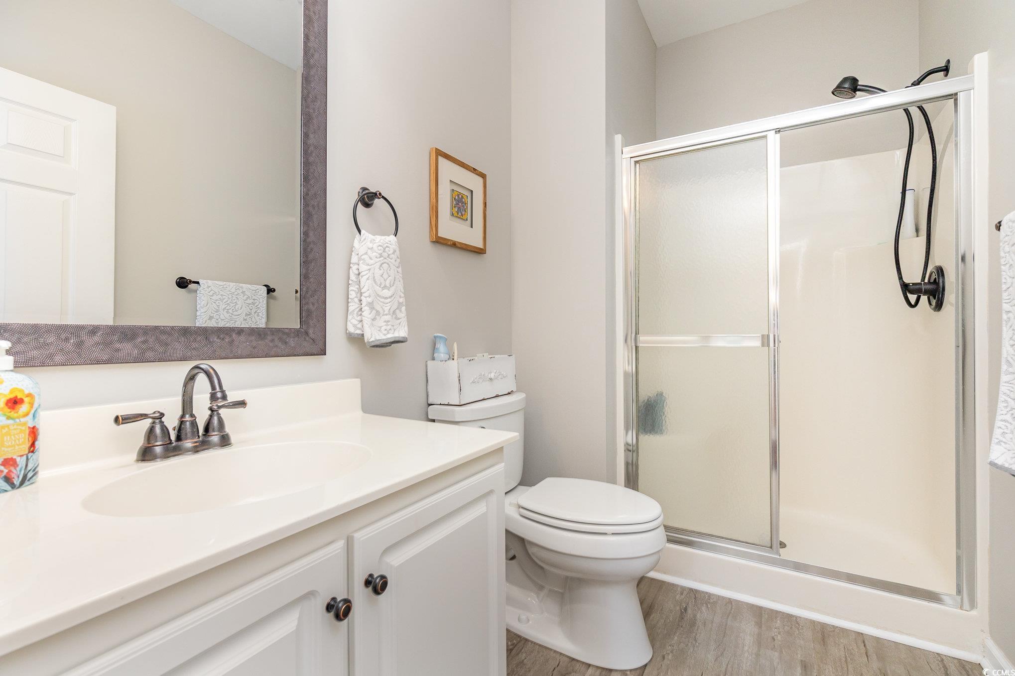 2478 Coastline Court, Unit 202 Murrells Inlet, SC 29576 - Photo 18 of 33 Bathroom featuring vanity, hardwood / wood-style f