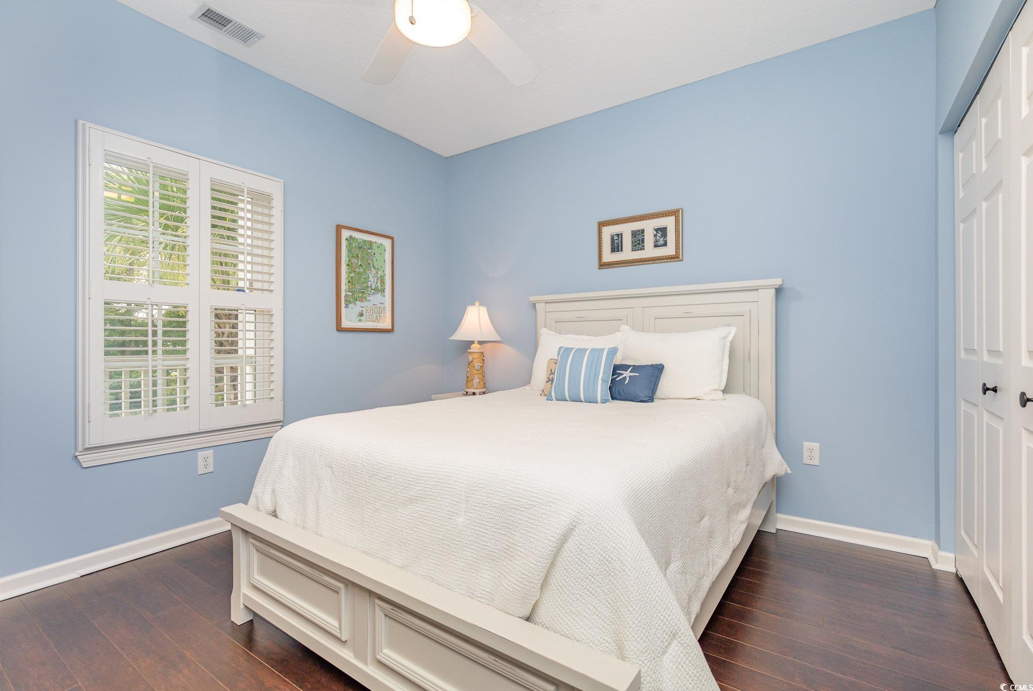 2478 Coastline Court, Unit 202 Murrells Inlet, SC 29576 - Photo 20 of 33 Bedroom with ceiling fan, a closet, and dark wood-