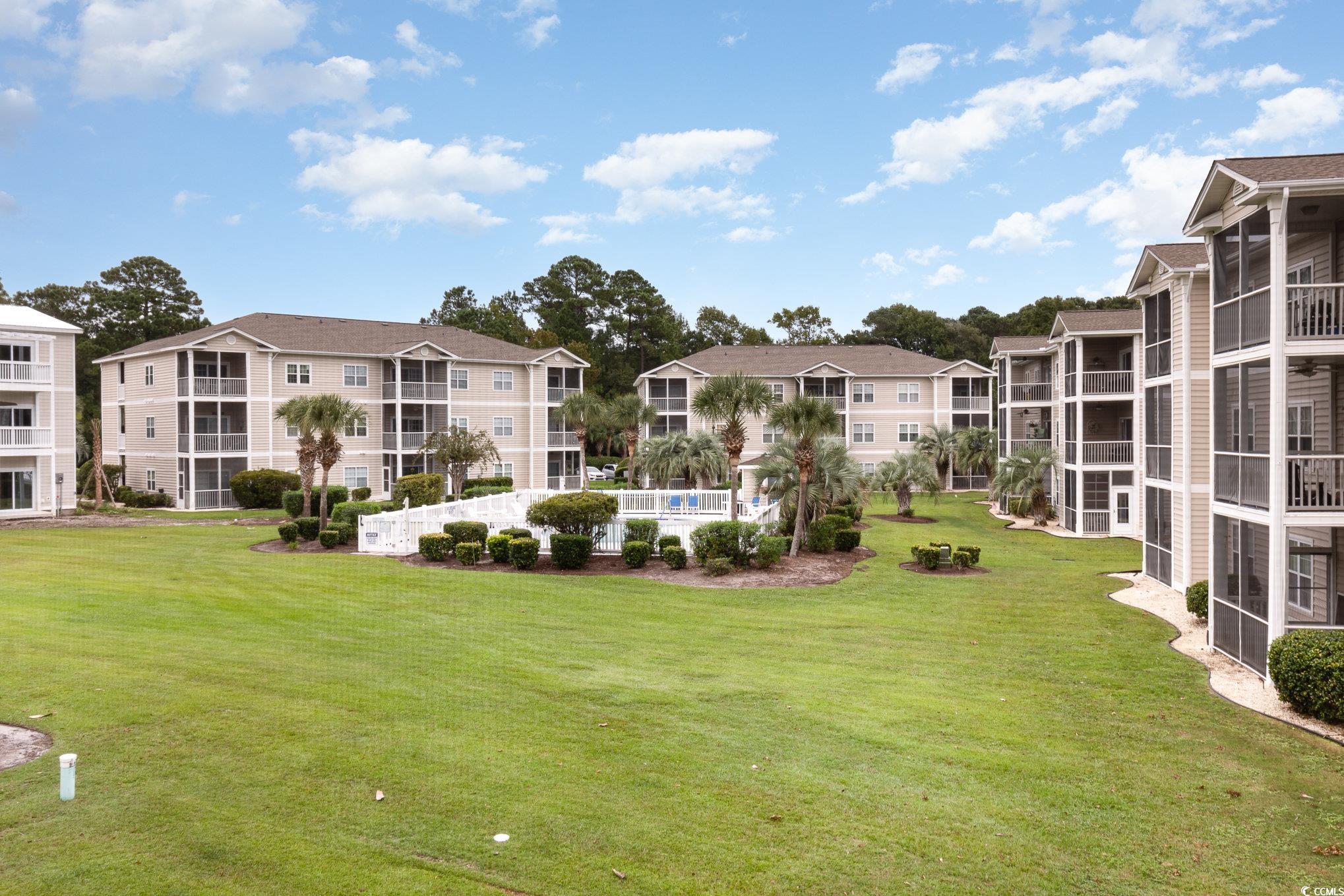 2478 Coastline Court, Unit 202 Murrells Inlet, SC 29576 - Photo 30 of 33 Surrounding community with a lawn