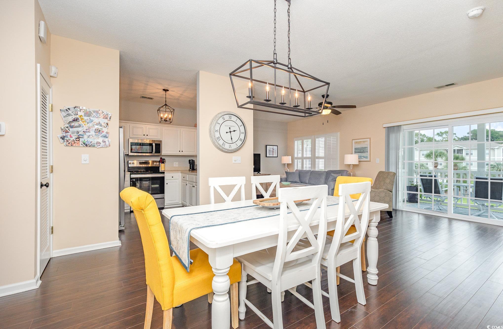 2478 Coastline Court, Unit 202 Murrells Inlet, SC 29576 - Photo 5 of 33 Dining room with ceiling fan with notable chandeli