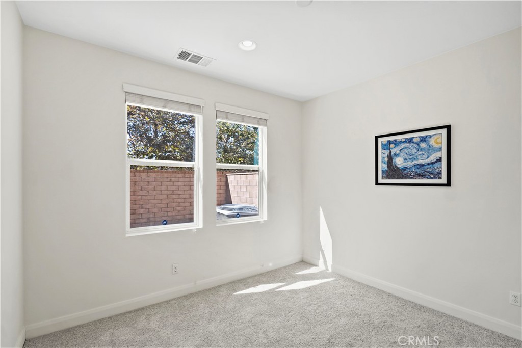 6670 Meadowlane Place Rancho Cucamonga, CA 91701 - Photo 11 of 26 an empty room with windows