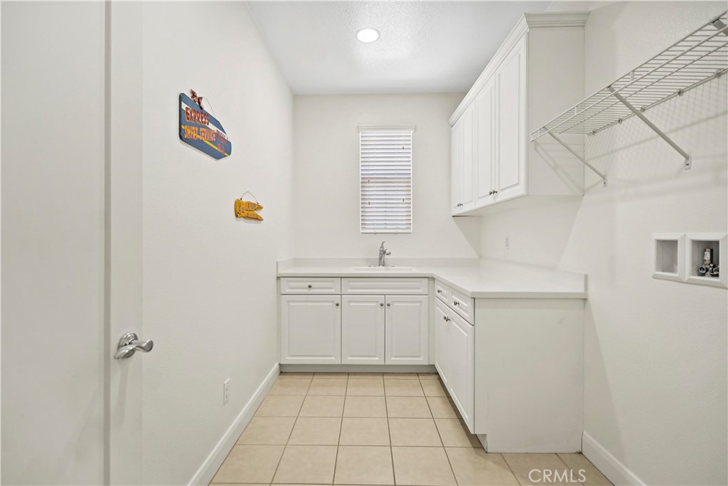 6670 Meadowlane Place Rancho Cucamonga, CA 91701 - Photo 19 of 26 a kitchen with a sink cabinets and a window