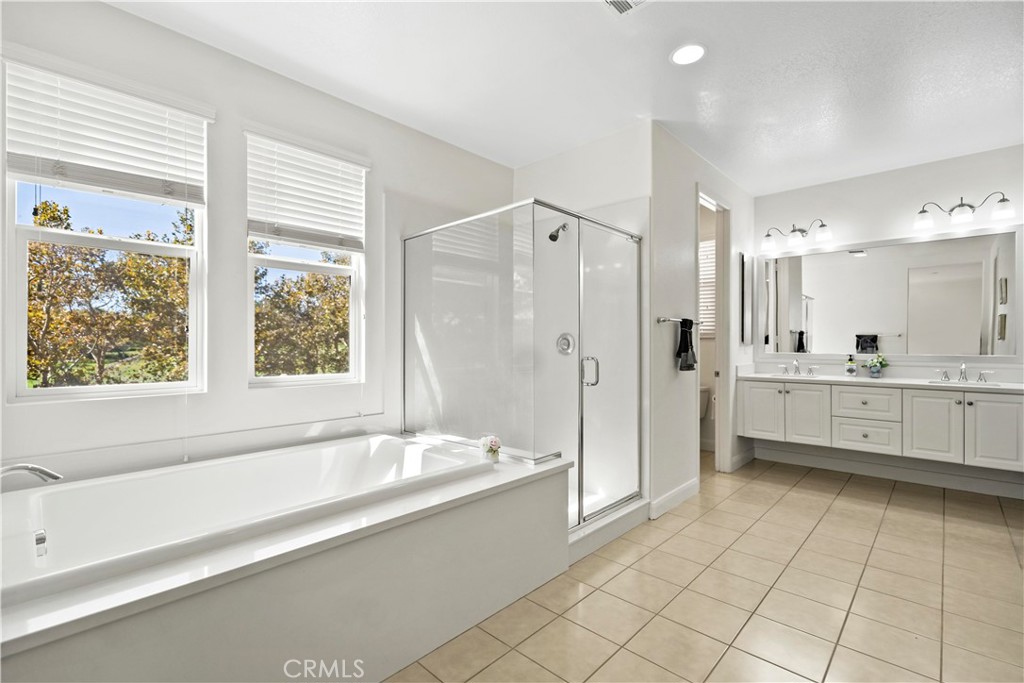 6670 Meadowlane Place Rancho Cucamonga, CA 91701 - Photo 24 of 26 a bathroom with a tub shower vanity and sink