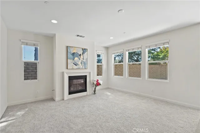 an empty room with furniture and a fireplace