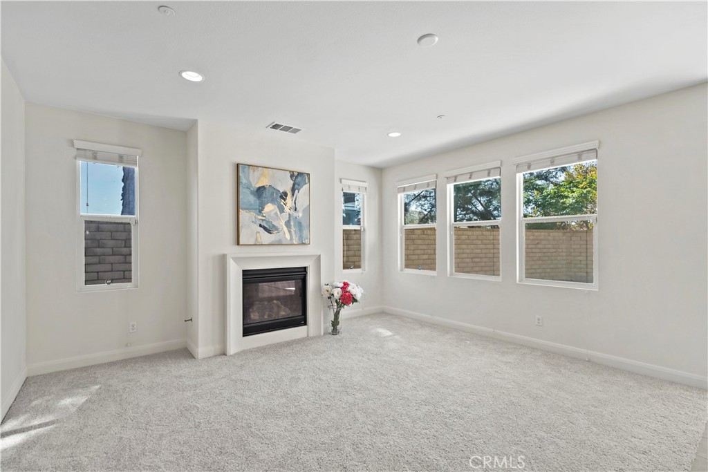 6670 Meadowlane Place Rancho Cucamonga, CA 91701 - Photo 4 of 26 an empty room with furniture and a fireplace