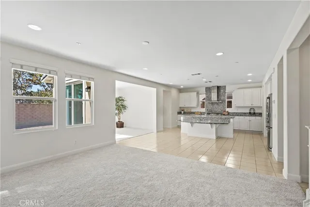 a view of kitchen with kitchen island stainless steel appliances refrigerator oven and cabinets