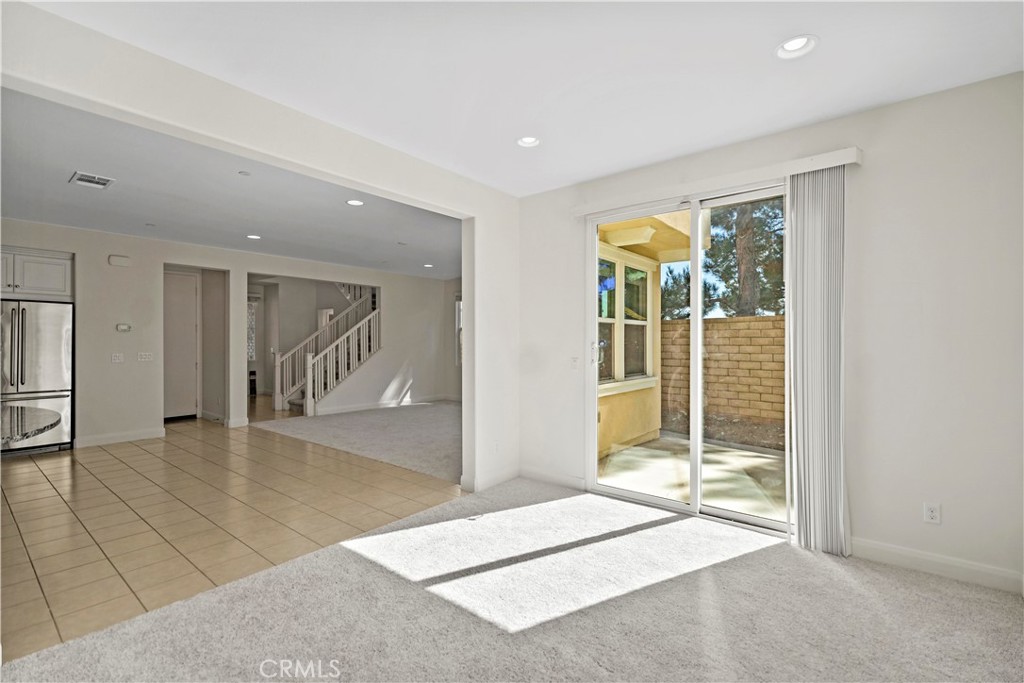 6670 Meadowlane Place Rancho Cucamonga, CA 91701 - Photo 9 of 26 a view of a hallway with wooden floor and a rug