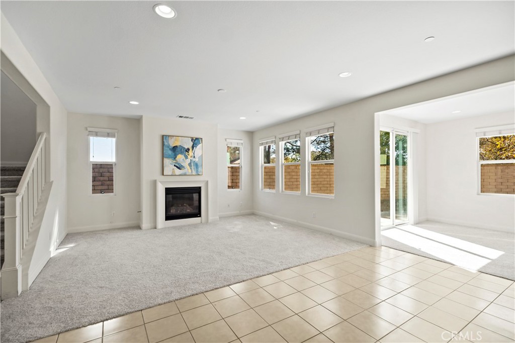 6670 Meadowlane Place Rancho Cucamonga, CA 91701 - Photo 10 of 26 a view of an empty room with a fireplace and a window