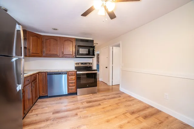 a kitchen with stainless steel appliances a refrigerator and a stove top oven