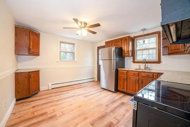 a kitchen with stainless steel appliances granite countertop a refrigerator a stove top oven a sink and dishwasher