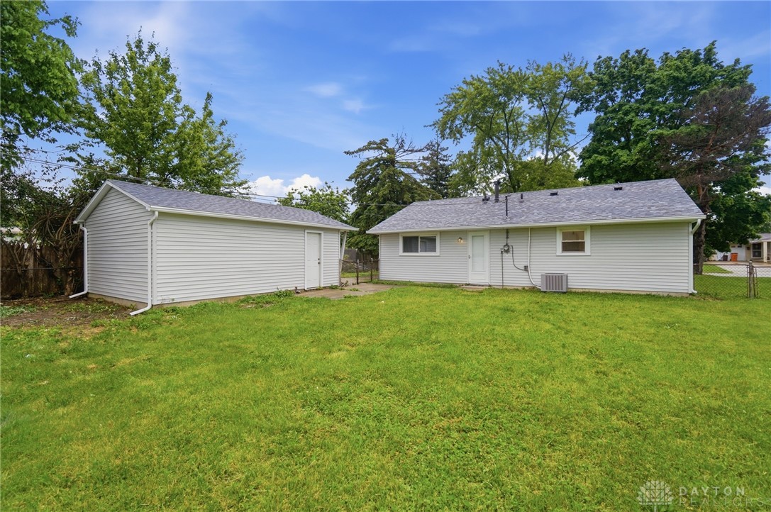 1923 Portage Path Springfield, OH 45506 - Photo 31 of 40 A spacious, verdant yard accompanies this charming residence and detached garage, providing ample outdoor living space.