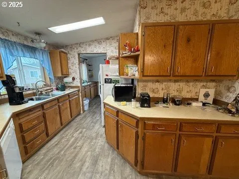 a kitchen with stainless steel appliances granite countertop a stove a sink dishwasher and a refrigerator