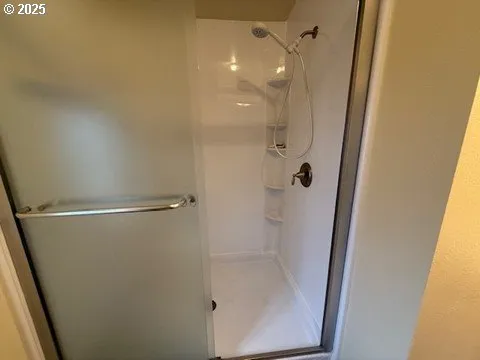 a bathroom with a glass shower door