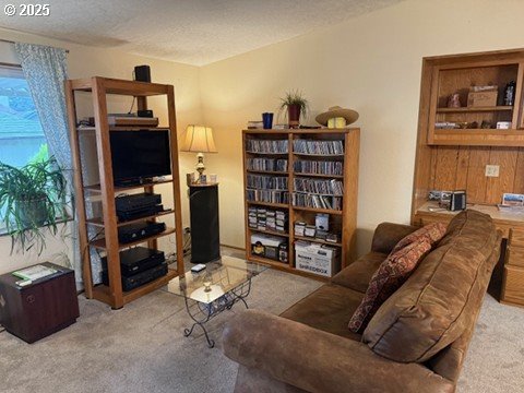 1199 North Terry Street, Unit 139 Eugene, OR 97402 - Photo 8 of 23 a living room with furniture and a shelf