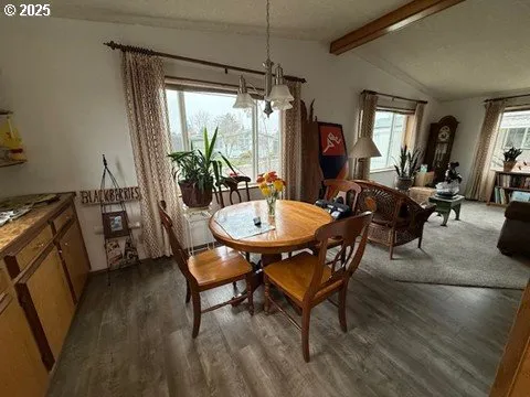 a dining room with furniture a chandelier and wooden floor
