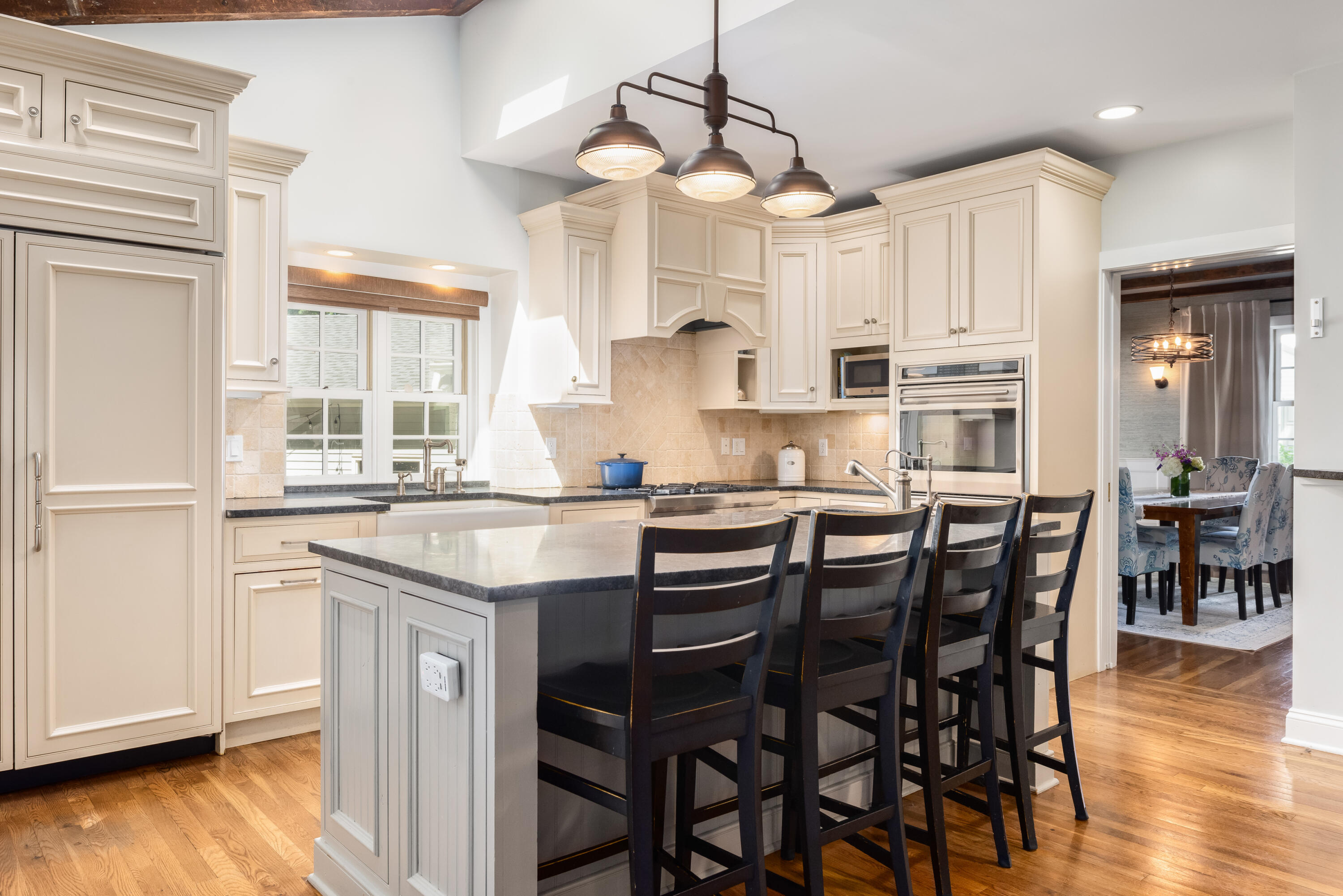 91 Hollow Tree Ridge Road Darien, CT 06820 - Photo 13 of 38 a kitchen with granite countertop a table chairs stove and cabinets