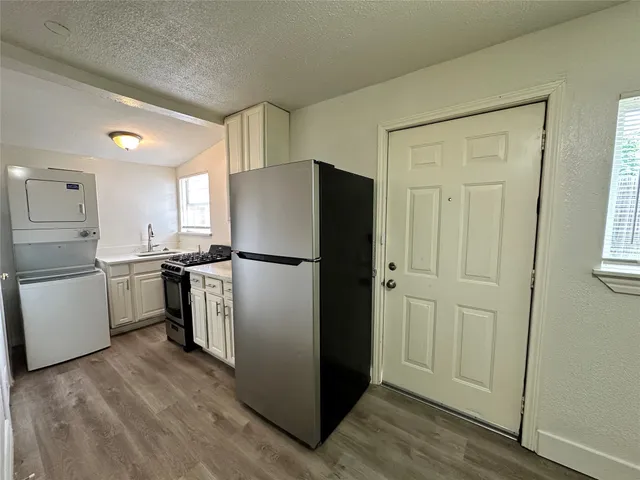 a kitchen with a refrigerator a sink and dishwasher