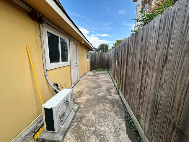 a view of a backyard with wooden fence