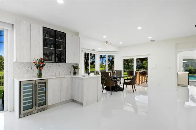 a kitchen with stainless steel appliances white cabinets and wooden floor