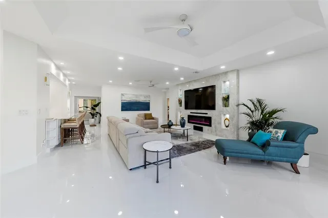 a bed room with a bed mirror and a chandelier