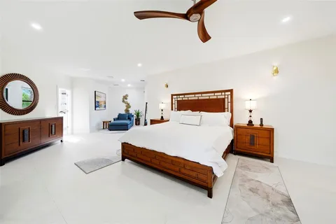 a bathroom with a granite countertop sink a toilet a mirror and shower