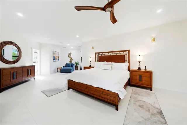 a bathroom with a granite countertop sink a toilet a mirror and shower