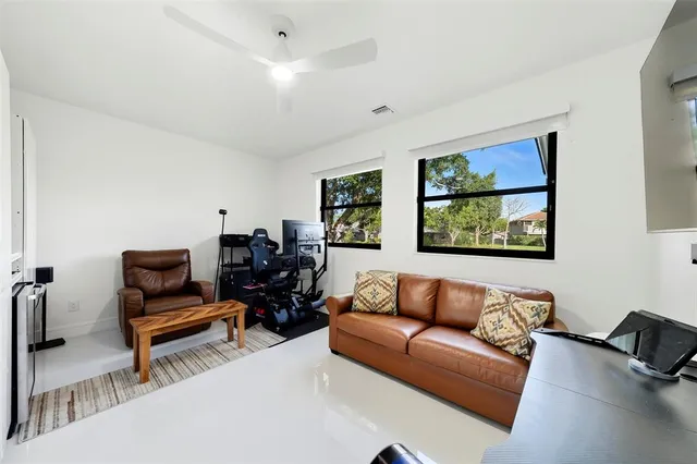 a view of a house with swimming pool and sitting area