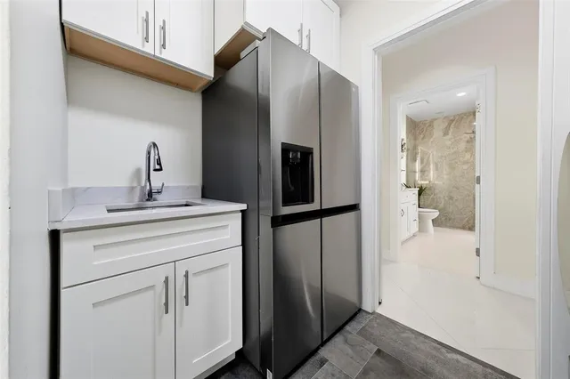 a picture of white wall with a white comforter