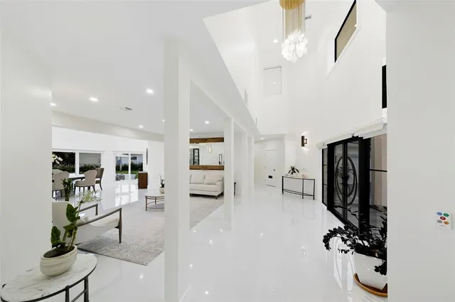 a view of a dining room with furniture and chandelier