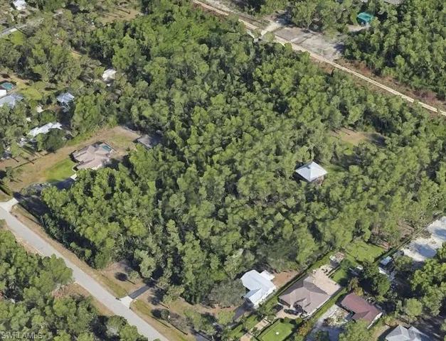 an aerial view of a houses with yard