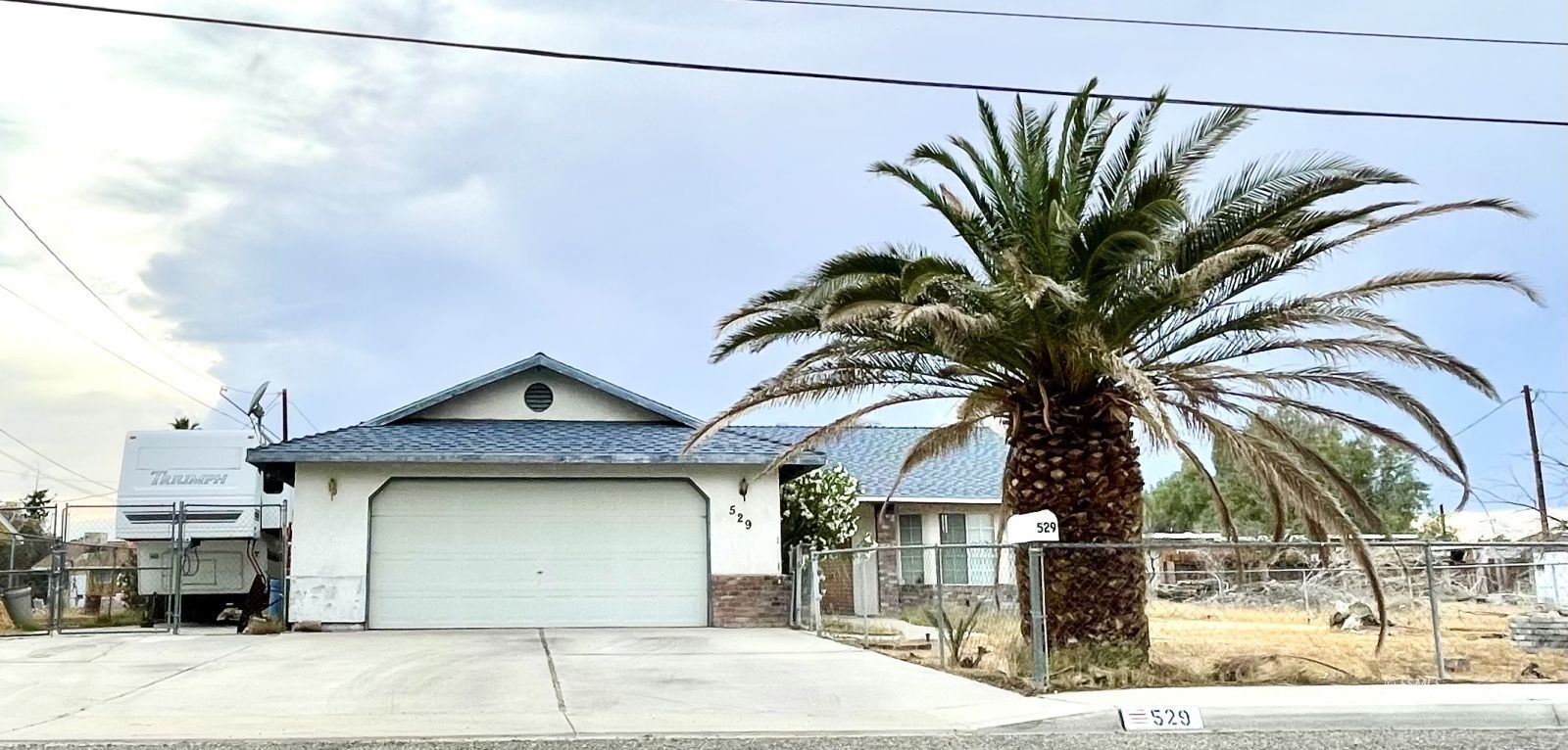 529 South Allen Street Ridgecrest, CA 93555 - Photo 1 of 17 a front view of a house with a garage