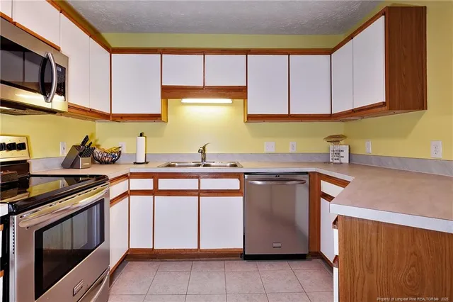 a kitchen with stainless steel appliances granite countertop a sink and a microwave