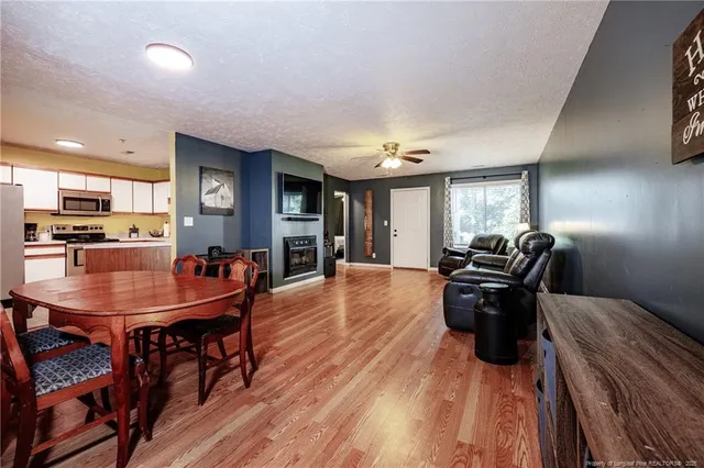 a dining room with furniture and wooden floor