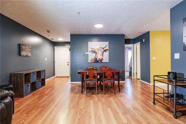 a dining room with furniture and wooden floor