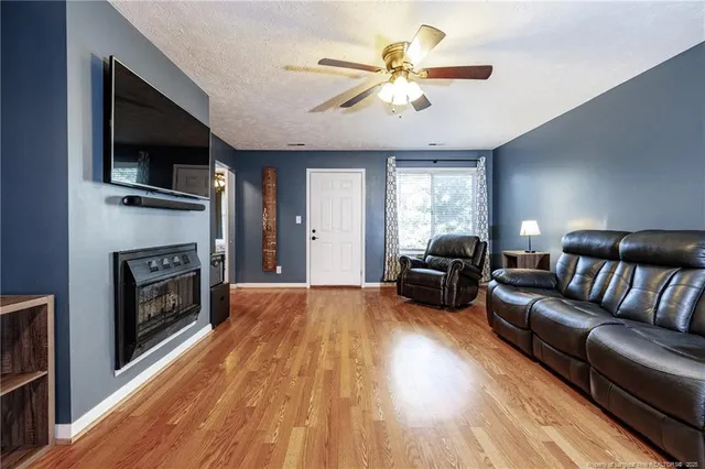 a living room with furniture fireplace and flat screen tv