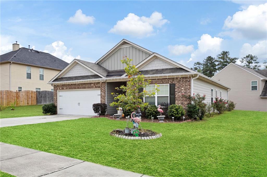 89 Dundee Crossing Dallas, GA 30132 - Photo 2 of 30 a front view of a house with a yard and garage