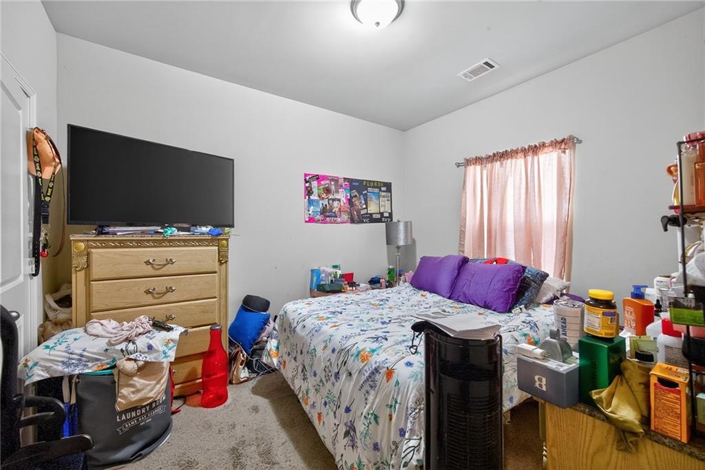 89 Dundee Crossing Dallas, GA 30132 - Photo 22 of 30 a bedroom with a bed and flat screen tv